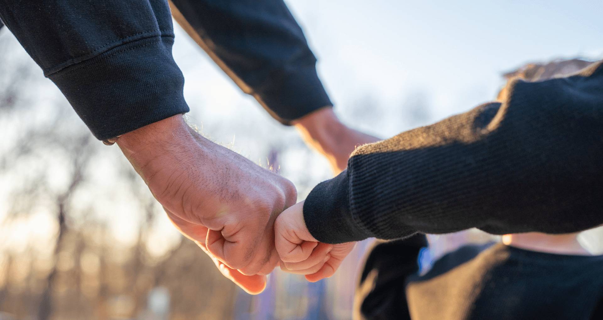 a man and a kid doing a fist bump