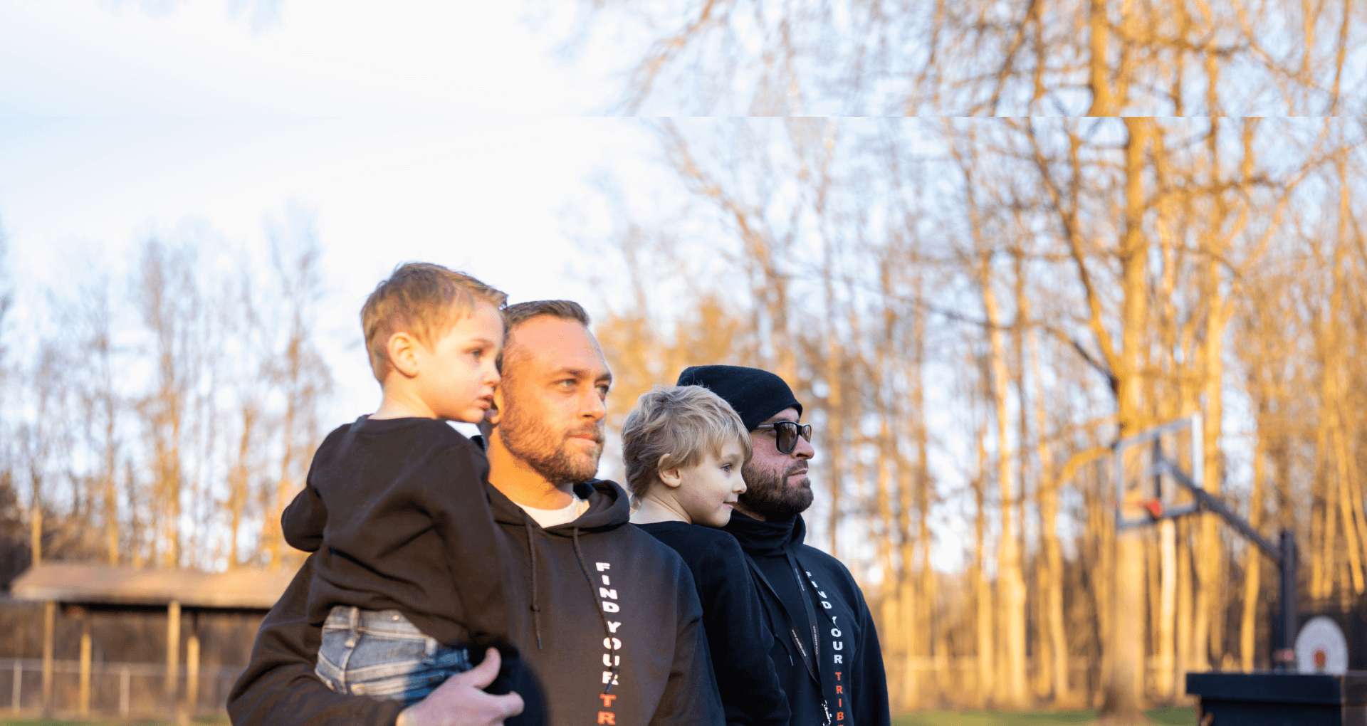 father and son standing in park basking in the sun