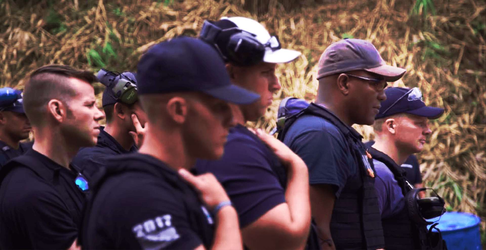 A group of law enforcement officers lined up in formation, ready for action.